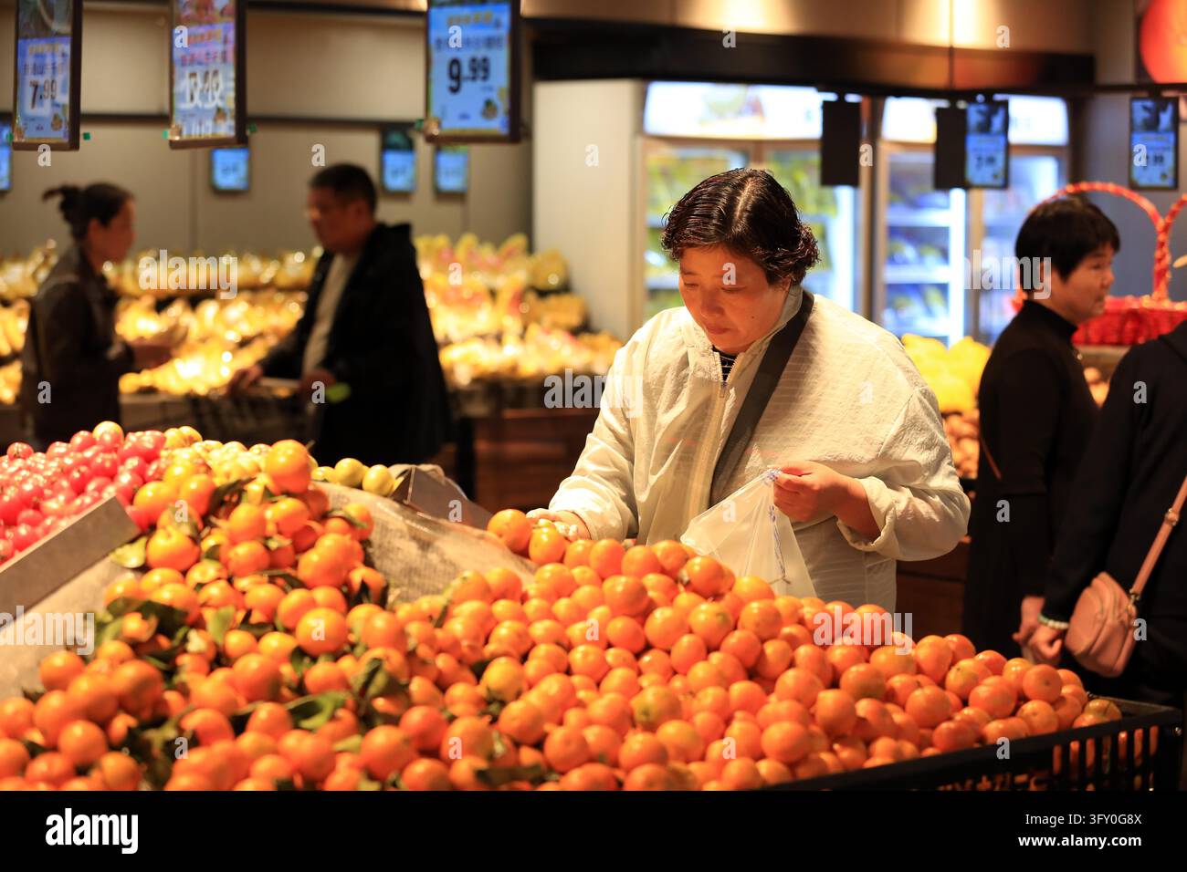 Shoppers browse goods at a supermarket in Huai'an, east China's Jiangsu ...
