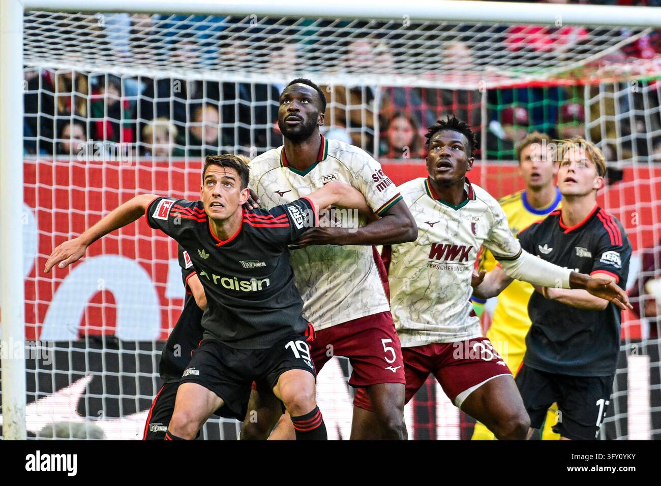 Prohibit Sign Cross Janik Haberer (Berlin, #19), Chrislain Matsima (FC Augsburg, #5) and ...