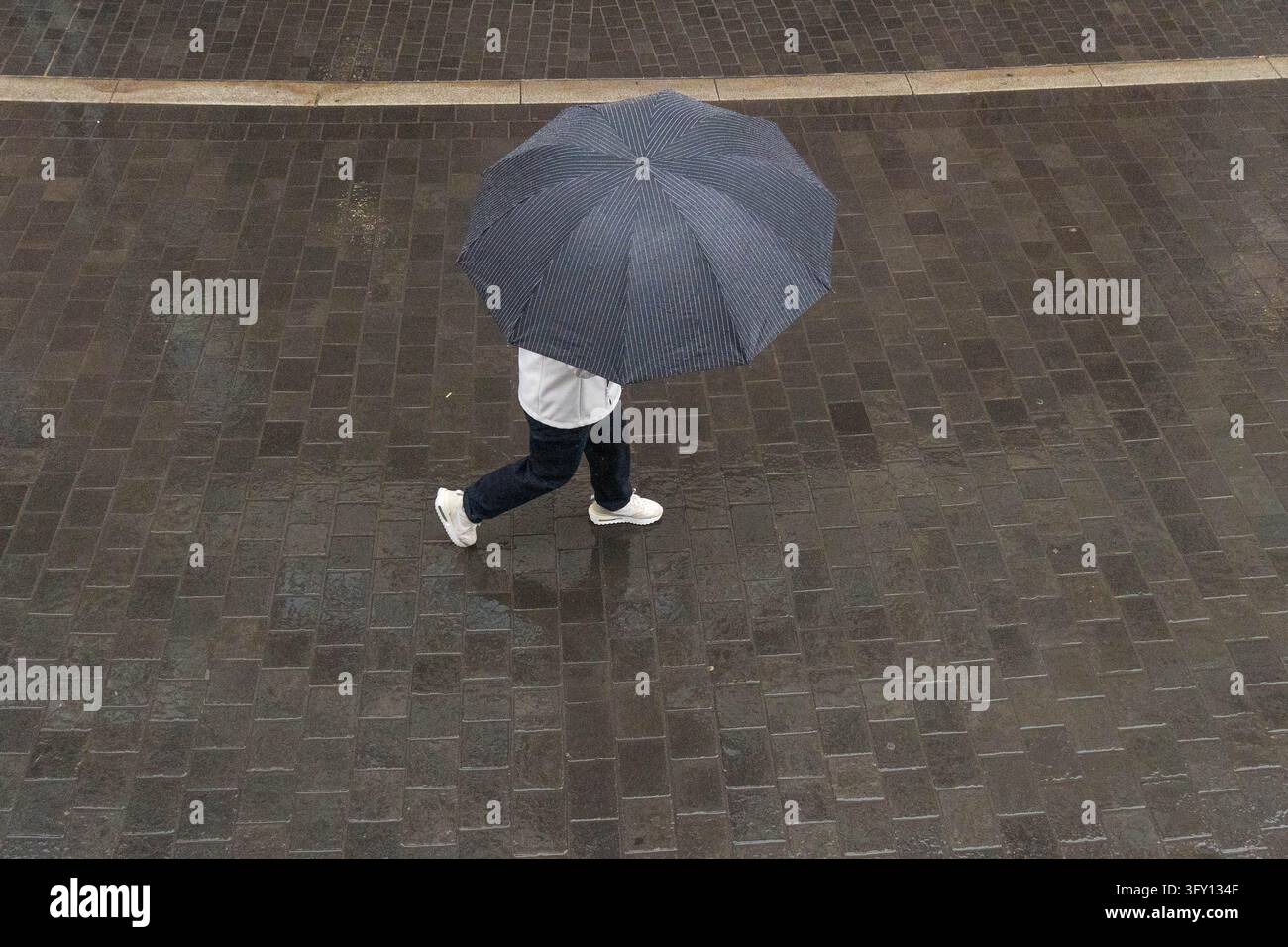 October 25, 2026, Frankfurt, Hesse, Germany: A person walks with an ...