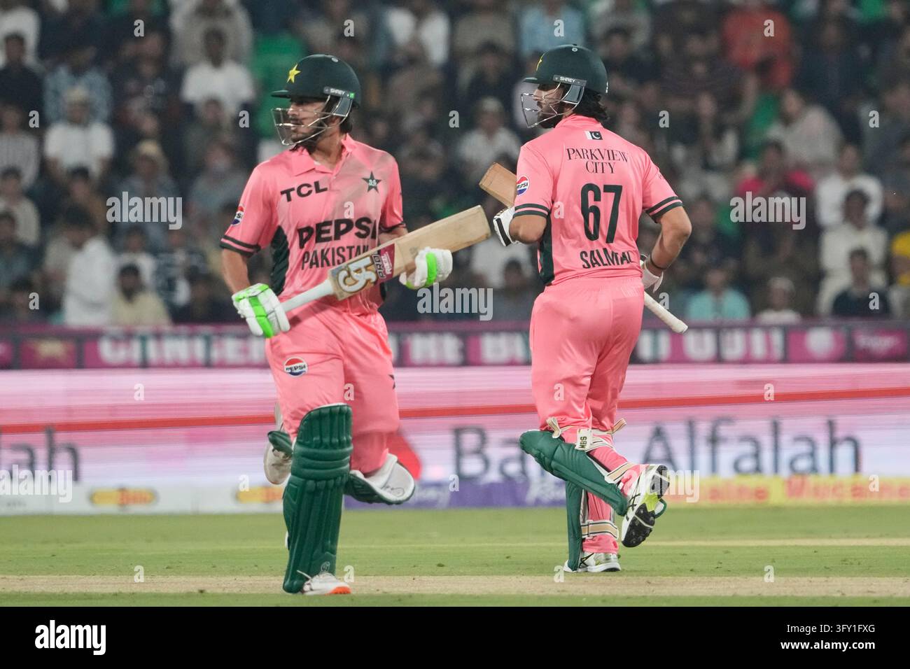 Wikets Vector Pakistan's Saad Baig and Salman Ali Agha run between the wickets during ...