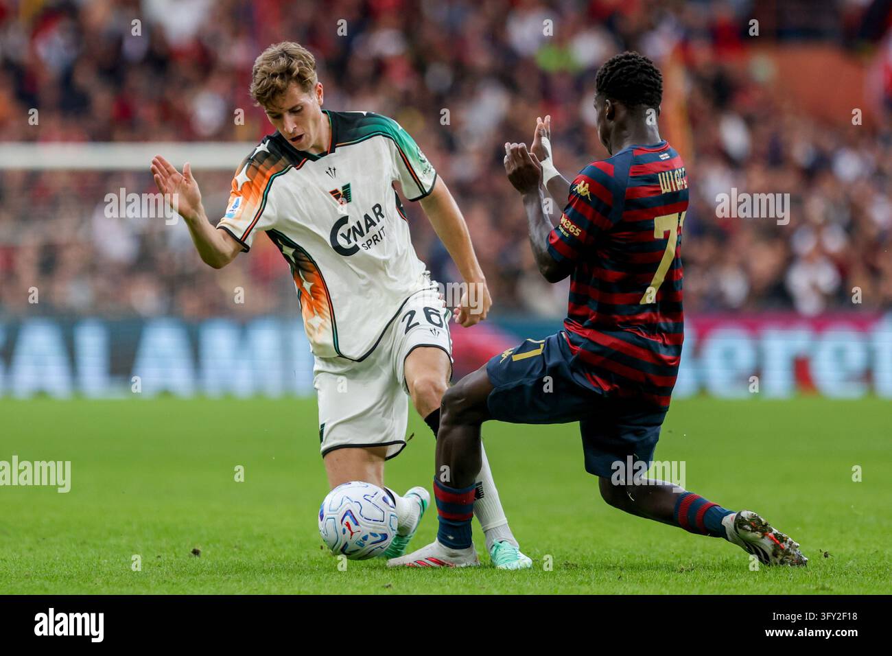 Basic Info Vector Genoa's Samuel Wiafe challenges Venezia's Toma Basic, left, during the ...