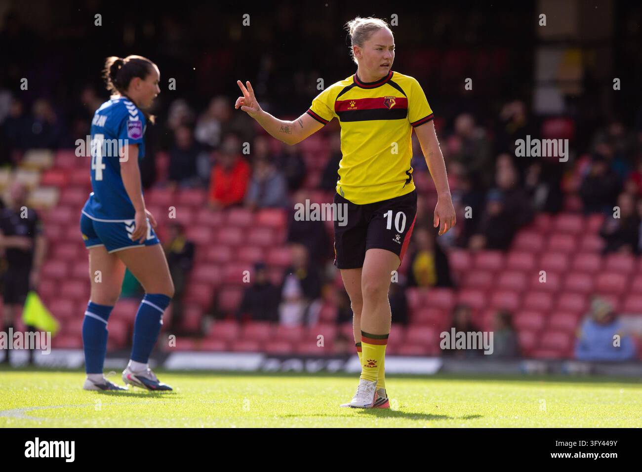 Phoebie Poole of Watford holds two finger up to her teammate during the ...