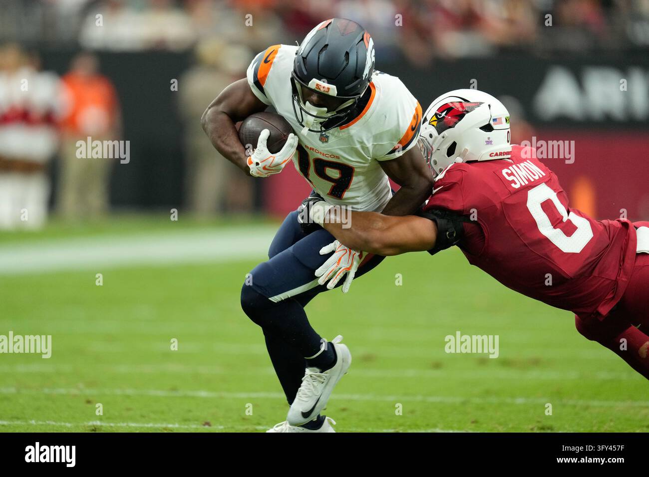 Denver Broncos wide receiver Marvin Mims Jr. (19) is tackled by Arizona ...