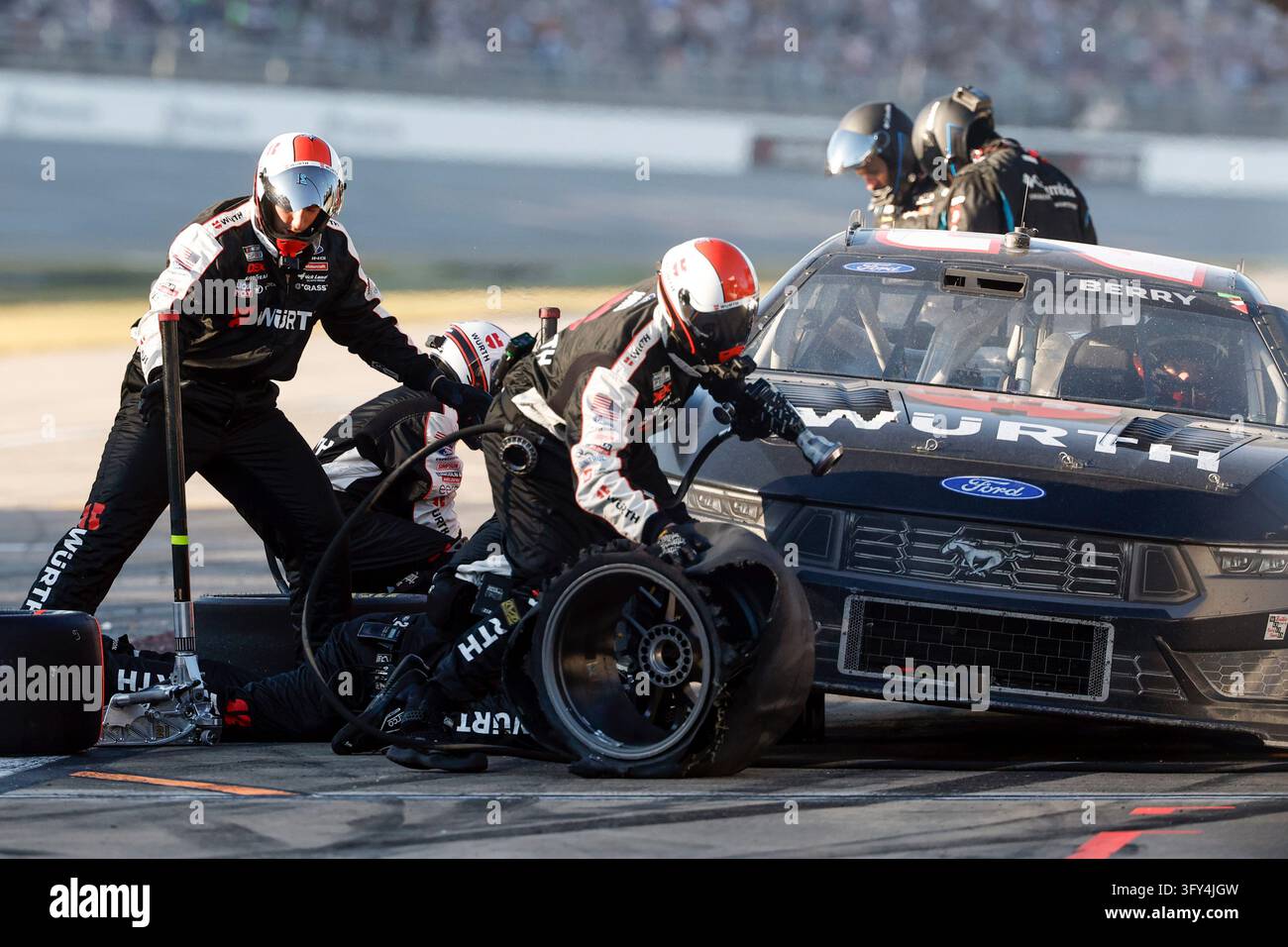 Crew members for Josh Berry change tires after a wreck during a NASCAR ...