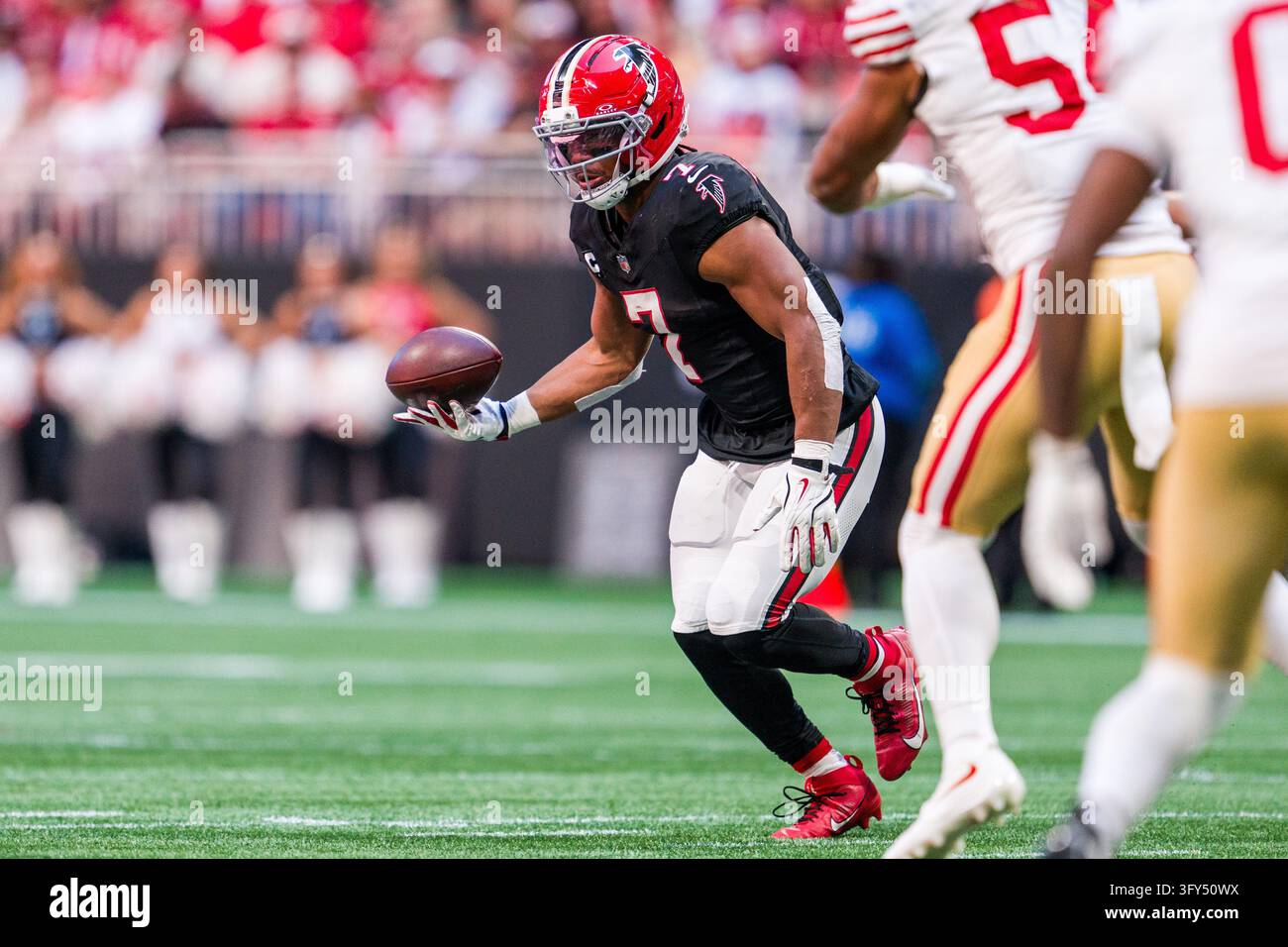 Commandres Running Back Atlanta Falcons running back Bijan Robinson (7) tosses the ball during ...