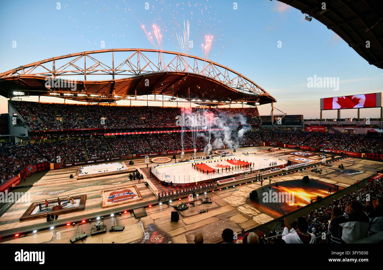 A Canadian flag is unfurled before the NHL Heritage Classic hockey game ...