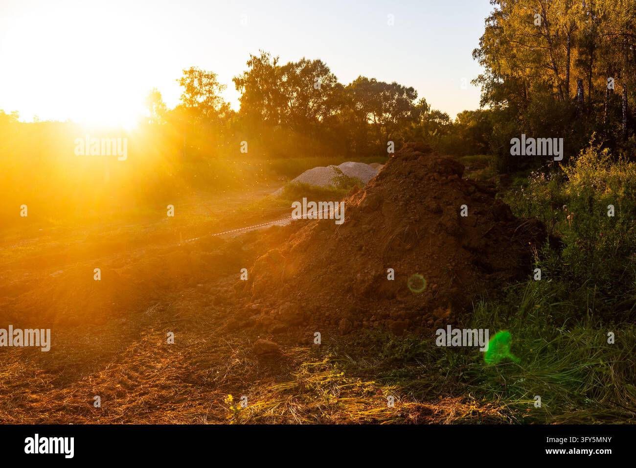 Large piles of excavated soil at a construction site with rough dirt ...