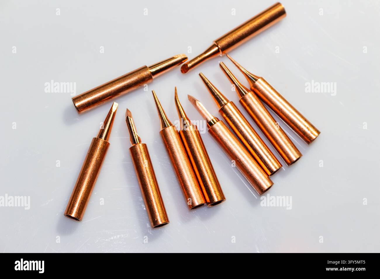 Collection White Background New collection of shiny copper soldering iron tips for precision ...