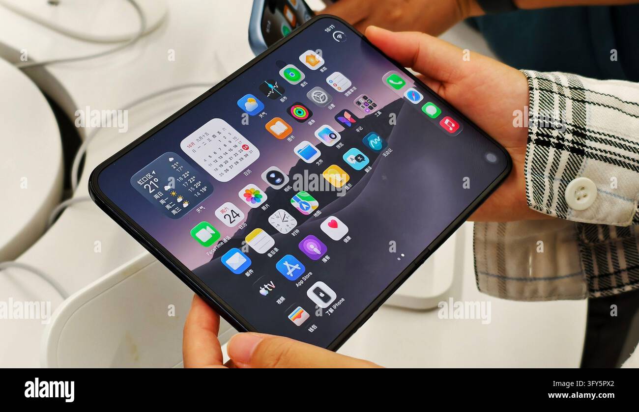 SHANGHAI, CHINA - OCTOBER 24, 2026 - A consumer is experiencing Apple's ...