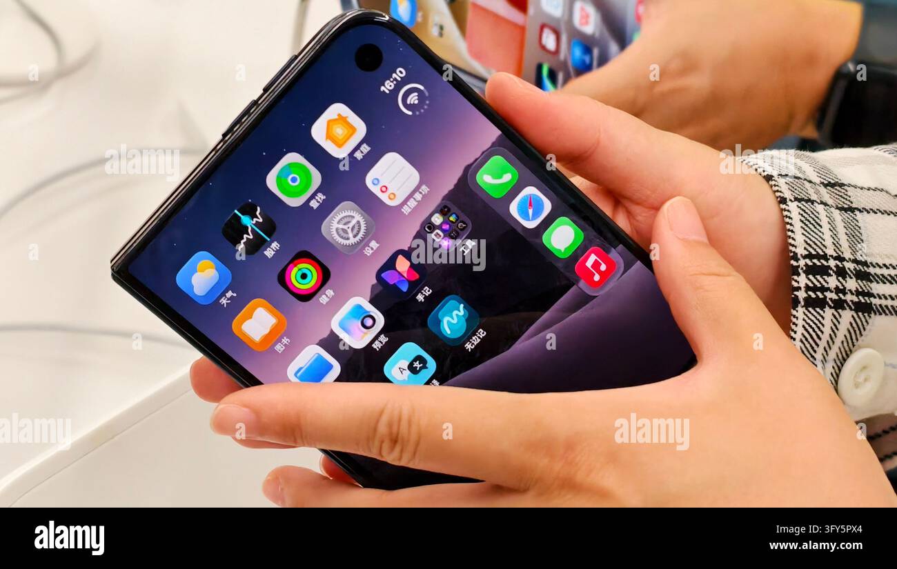 SHANGHAI, CHINA - OCTOBER 24, 2026 - A consumer is experiencing Apple's ...