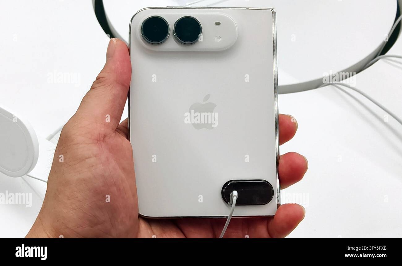 SHANGHAI, CHINA - OCTOBER 24, 2026 - A consumer is experiencing Apple's ...