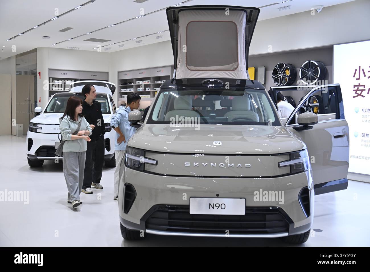 A customer selects a new energy vehicle at a Xiaomi store in Longfor ...