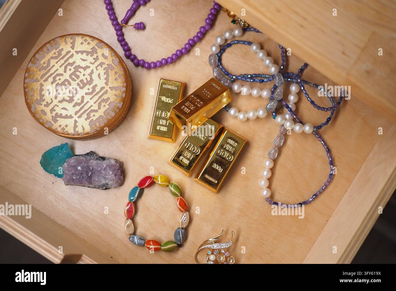 Jewelry and gold bars arranged inside a wooden drawer Stock Photo - Alamy