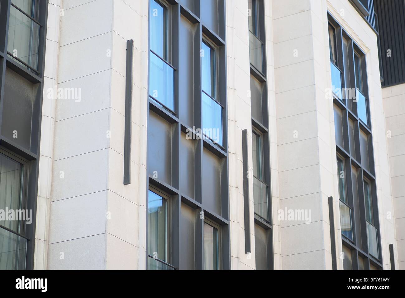 Daylight view of windows and stone panels on an office building Stock ...