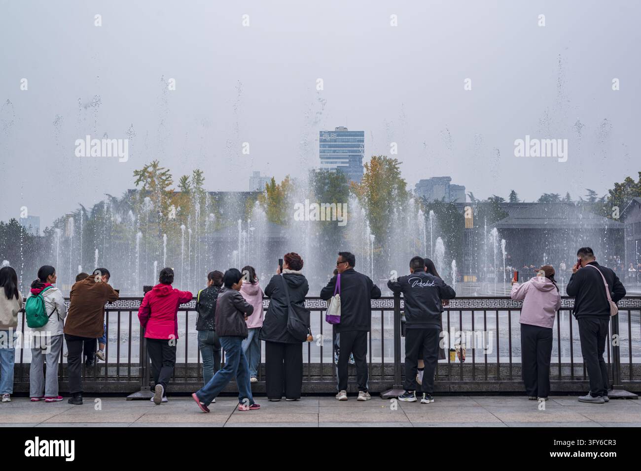 Tourists gather to watch the musical fountain show at the north square ...