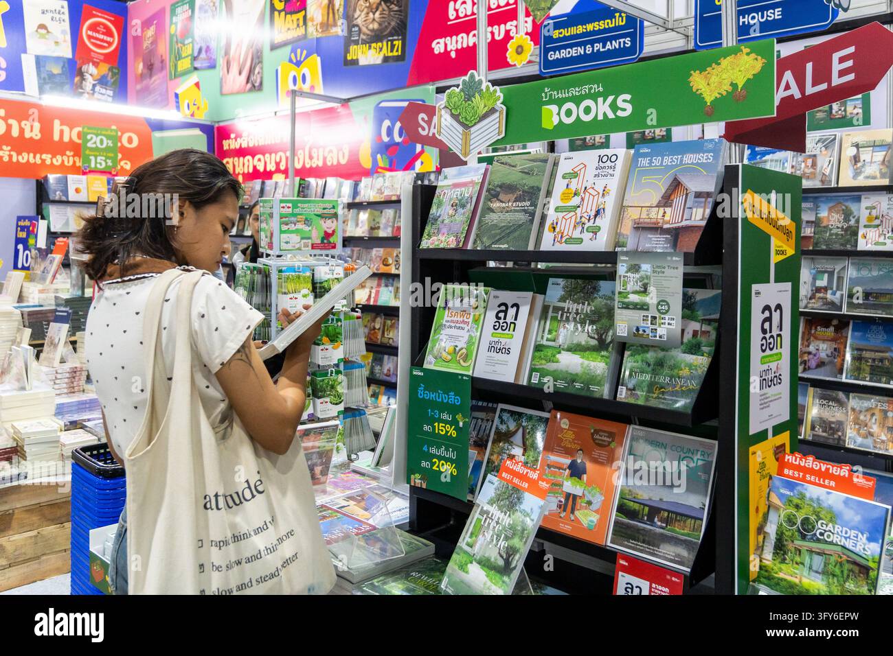 A woman browsing a book in the nature and architecture section during ...