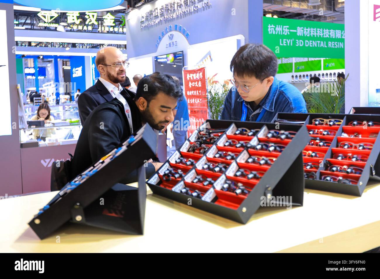 Comp Learning Foreign buyers learn about medical devices at the easysee booth during ...