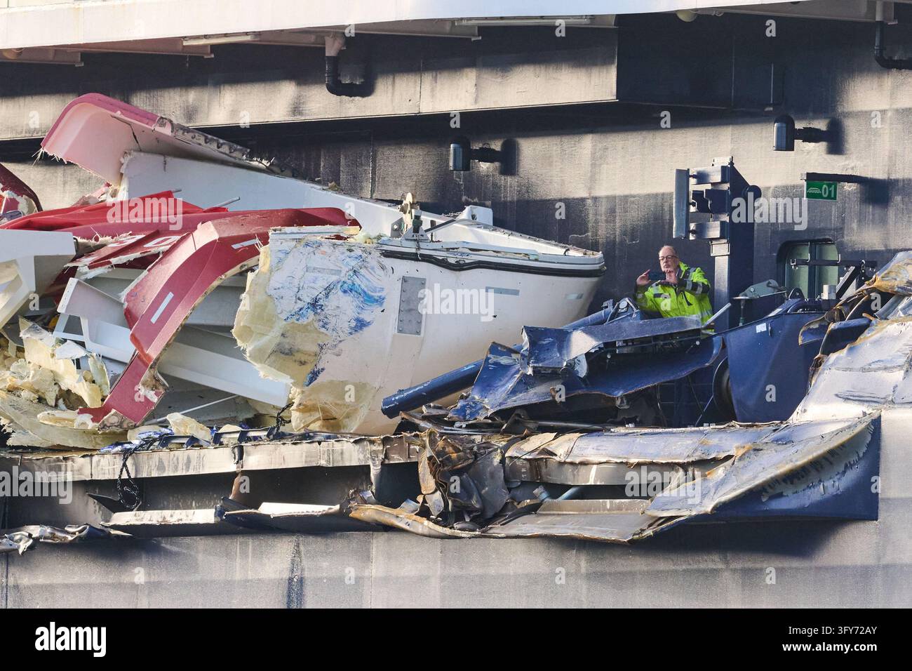 26 October 2026, Bremen, Bremerhaven: Two men are assessing the damage ...