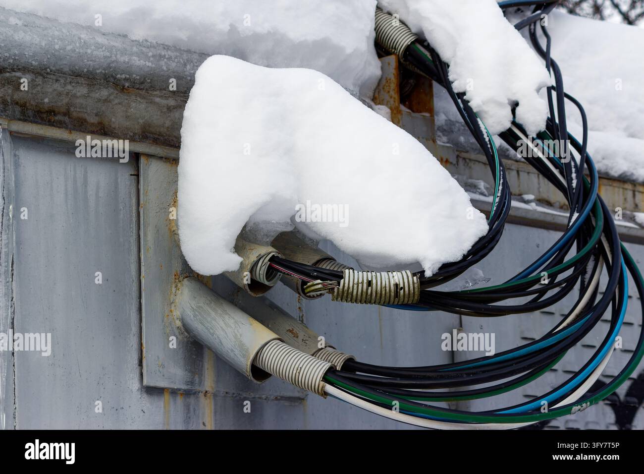 Heavy power cables entering a metal electrical substation enclosure ...