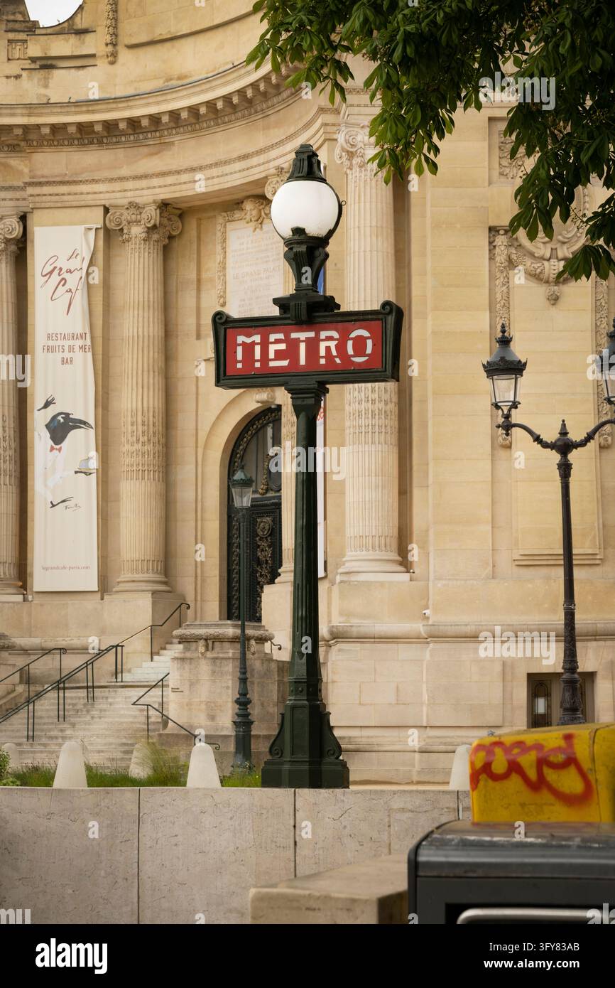 Retro Metro sign post in Paris France with historic Grand Palais ...