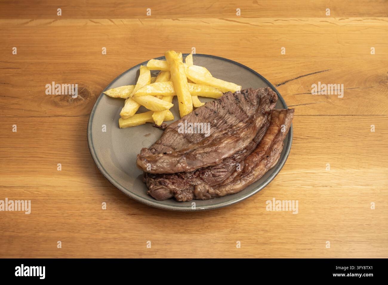 On Top Table Grilled picanha steak sliced and served on a rustic gray plate with ...