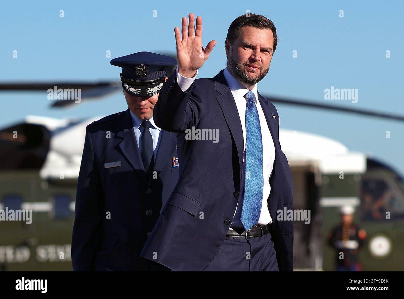 Vice President JD Vance waves as he walks to board Air Force Two ...