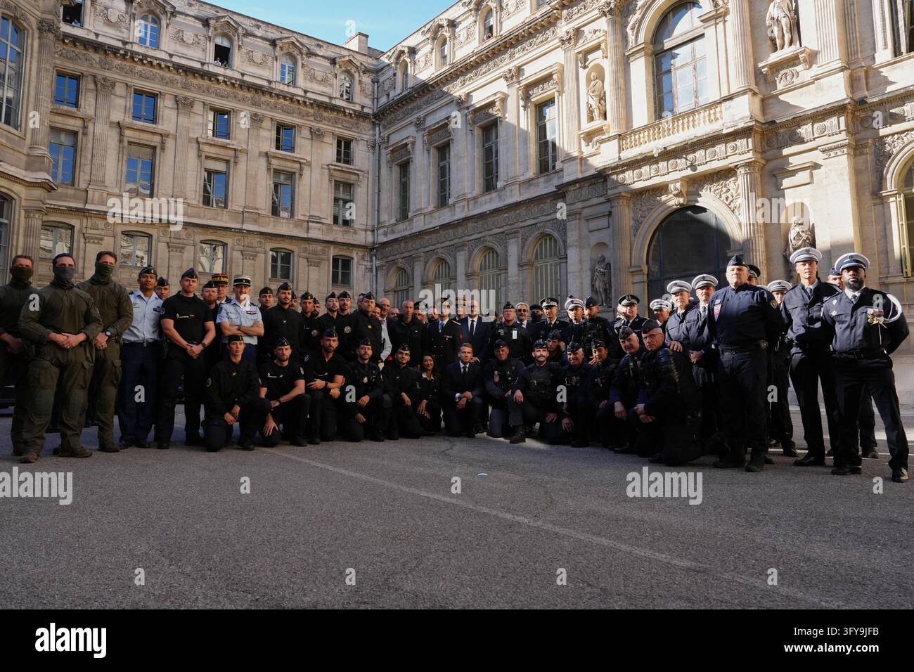 French President Emmanuel Macron poses with the police force at the ...