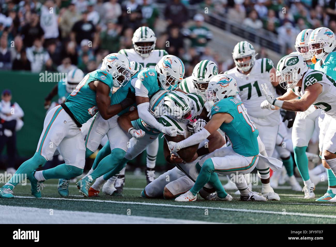 New York Jets running back Braelon Allen (0) runs with the ball tackled ...