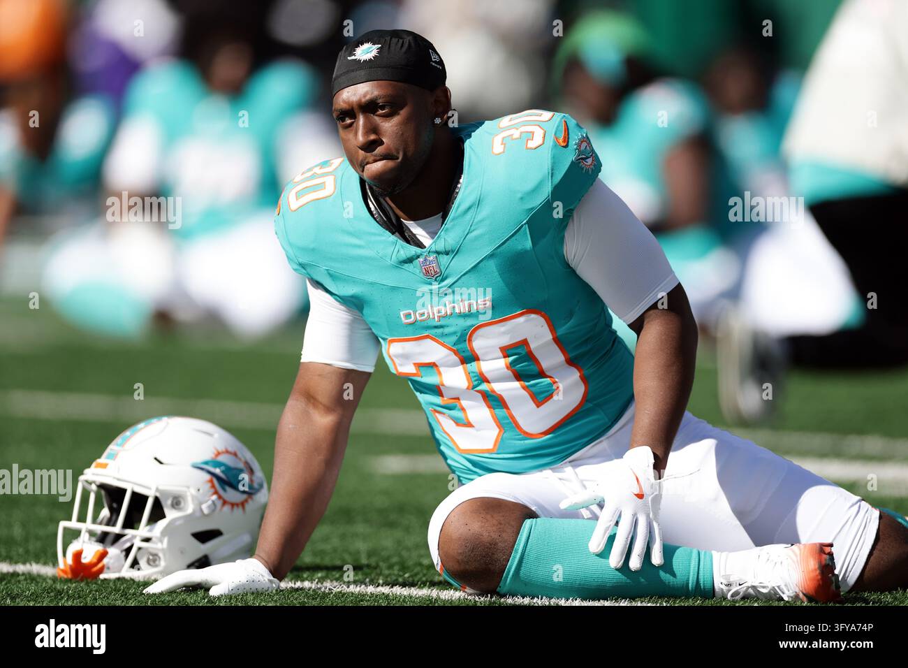 Miami Dolphins running back Kaytron Allen (30) warms up before an NFL ...