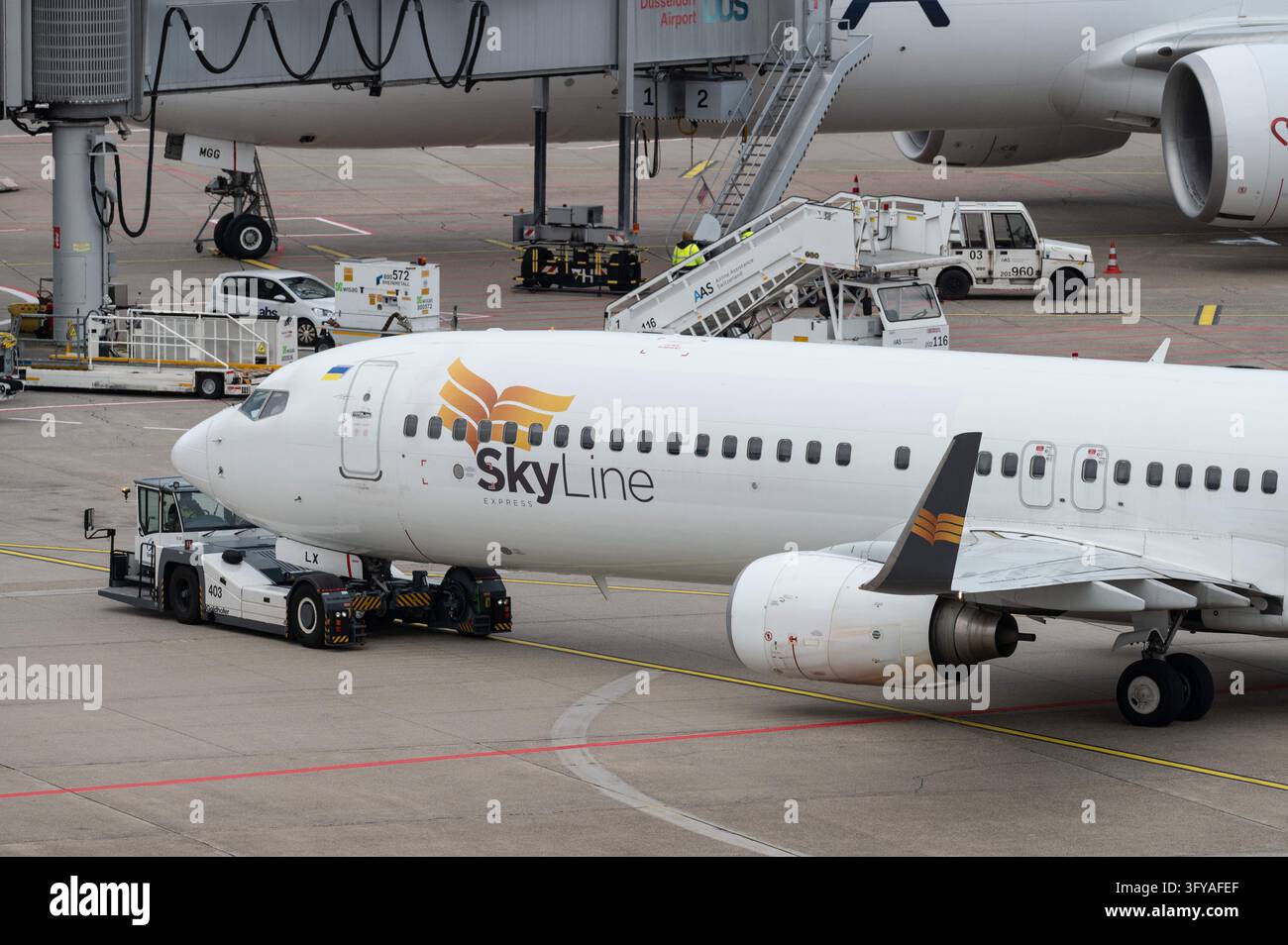 A Skyline Express Boeing 737, call sign UR-SLX, is being pushed from ...