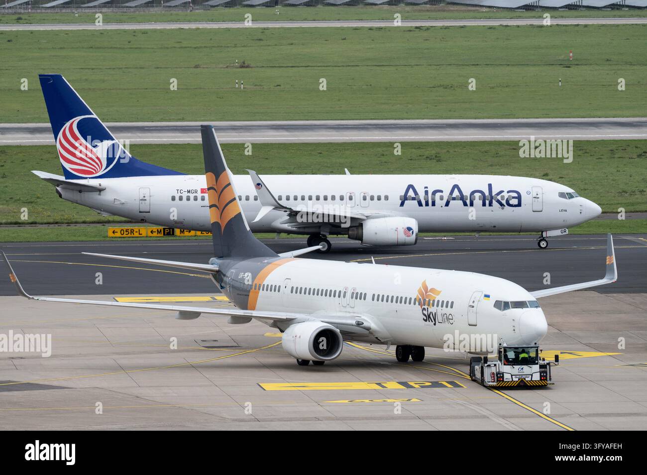 File Processing Background A Skyline Express Boeing 737, call sign UR-SLX, is being pushed from ...
