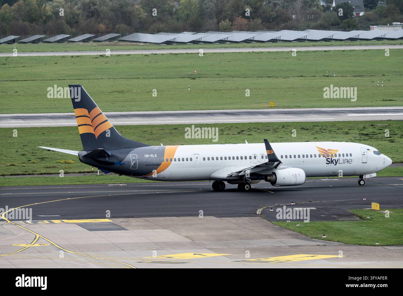 A Boeing 737 of Skyline Express, call sign UR-SLX, taxis for takeoff at ...