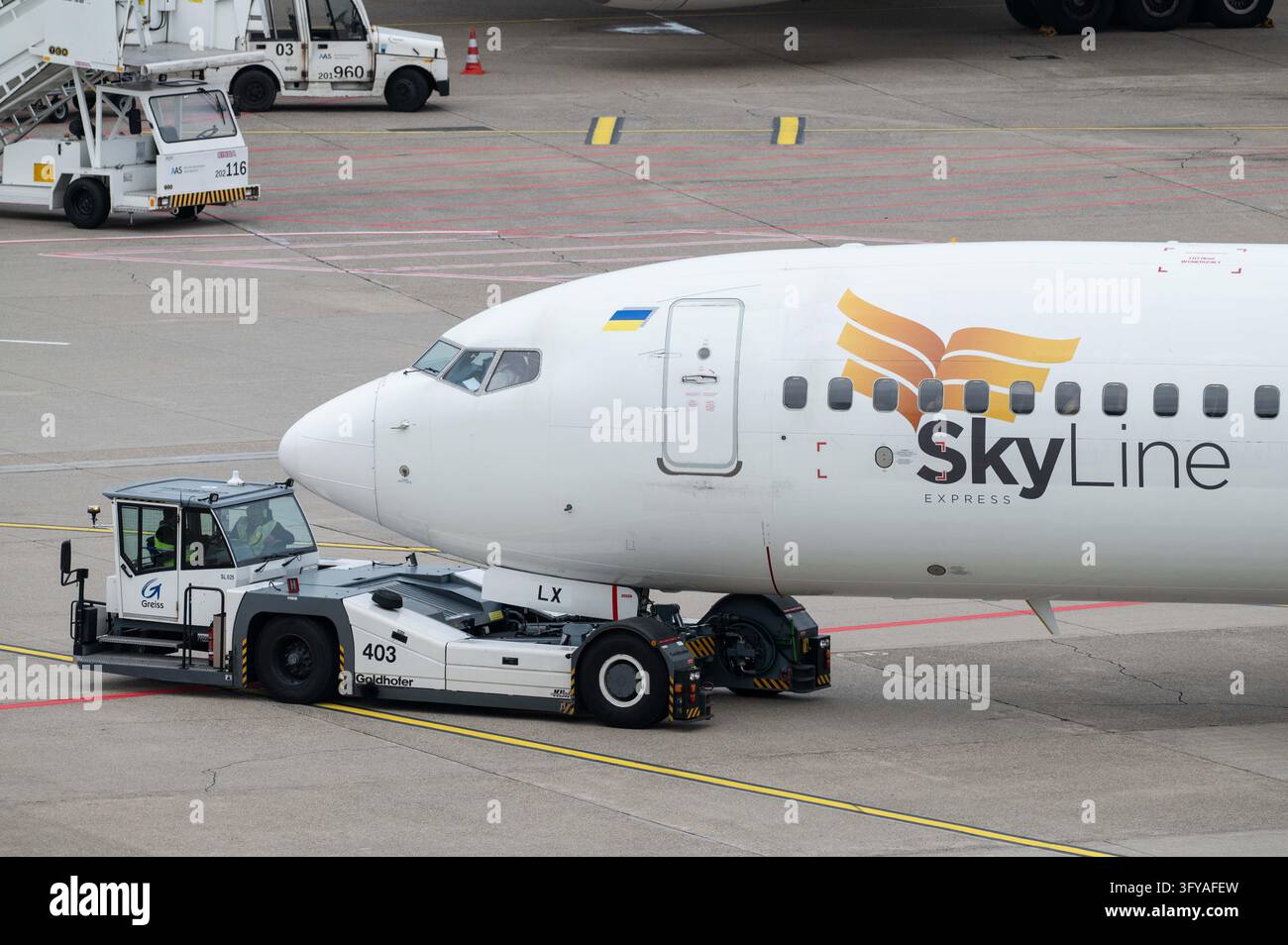 A Skyline Express Boeing 737, call sign UR-SLX, is being pushed from ...