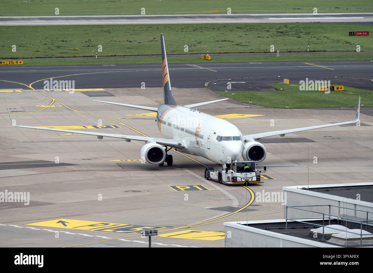 A Skyline Express Boeing 737, call sign UR-SLX, is being pushed from ...