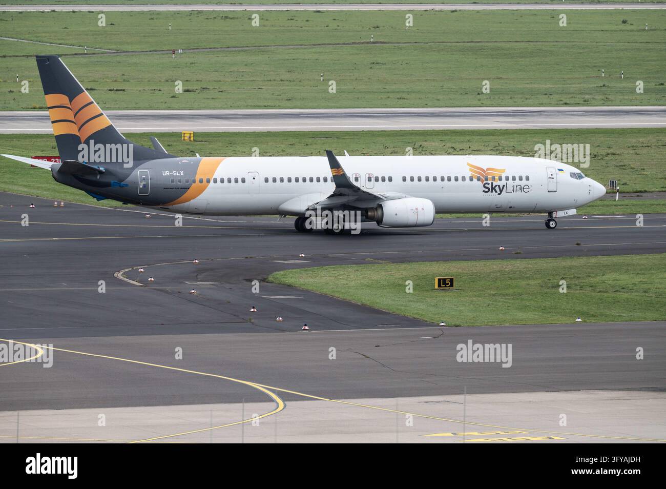 A Boeing 737 of Skyline Express, call sign UR-SLX, taxis for takeoff at ...