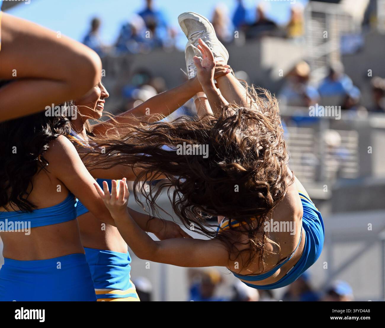 PASADENA, CA - OCTOBER 24: A UCLA Bruins cheerleader tumbles awkwardly ...
