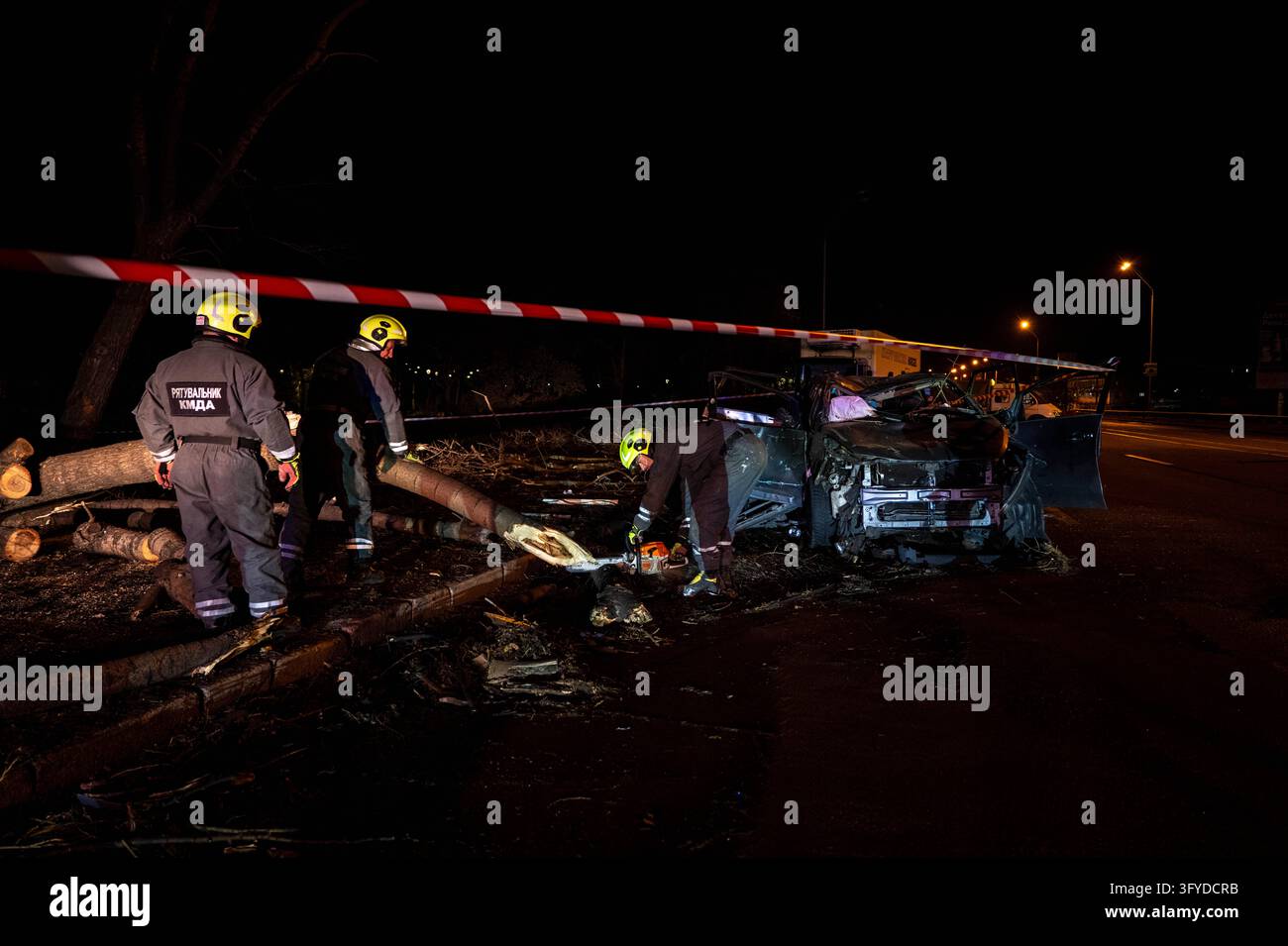 Emergency workers clear debris and damaged road infrastructure near a ...