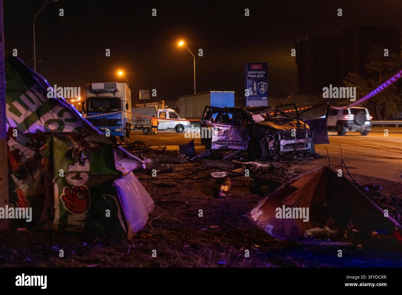 Emergency workers clear debris and damaged road infrastructure near a ...