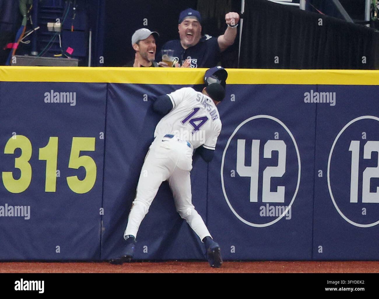 Tampa Bay Rays left fielder Chandler Simpson (14) slams into the wall ...