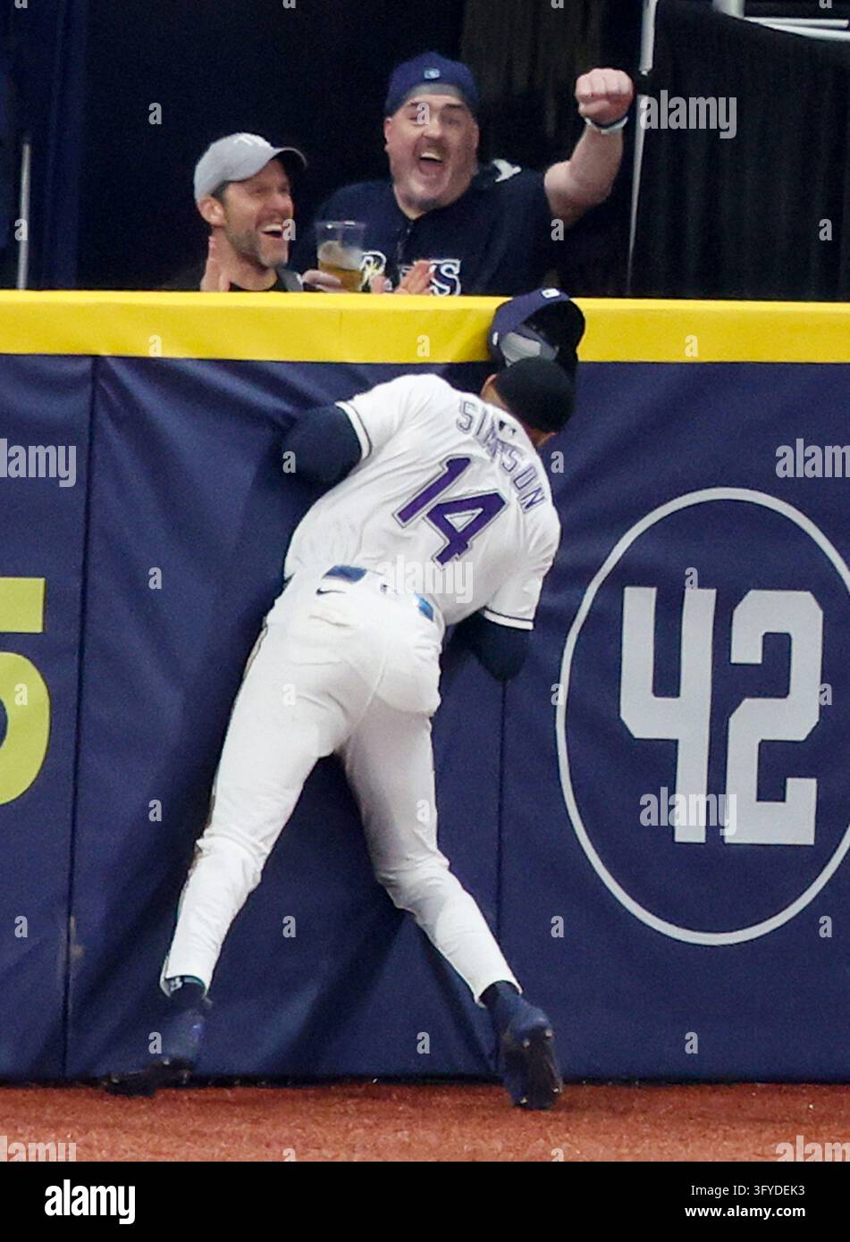 Tampa Bay Rays left fielder Chandler Simpson (14) slams into the wall ...