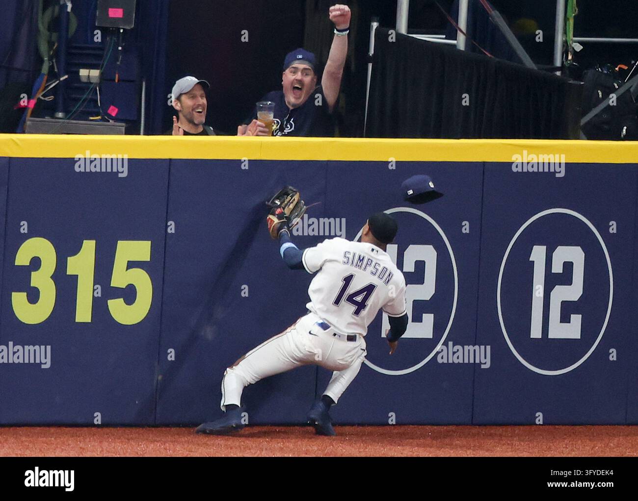 Tampa Bay Rays left fielder Chandler Simpson (14) slams into the wall ...