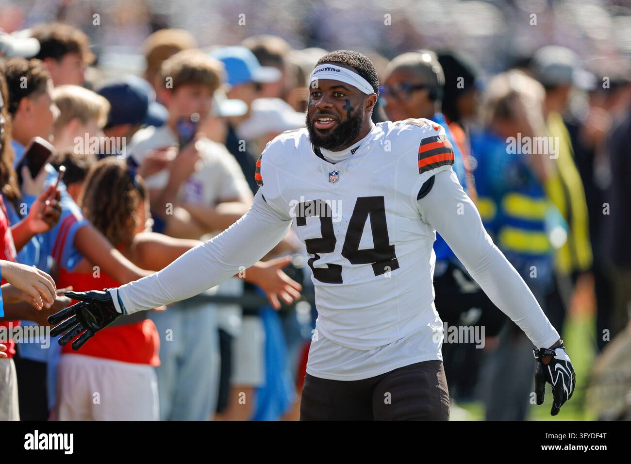 Cleveland Browns safety Daniel Thomas (24) greets fans as he walks off ...