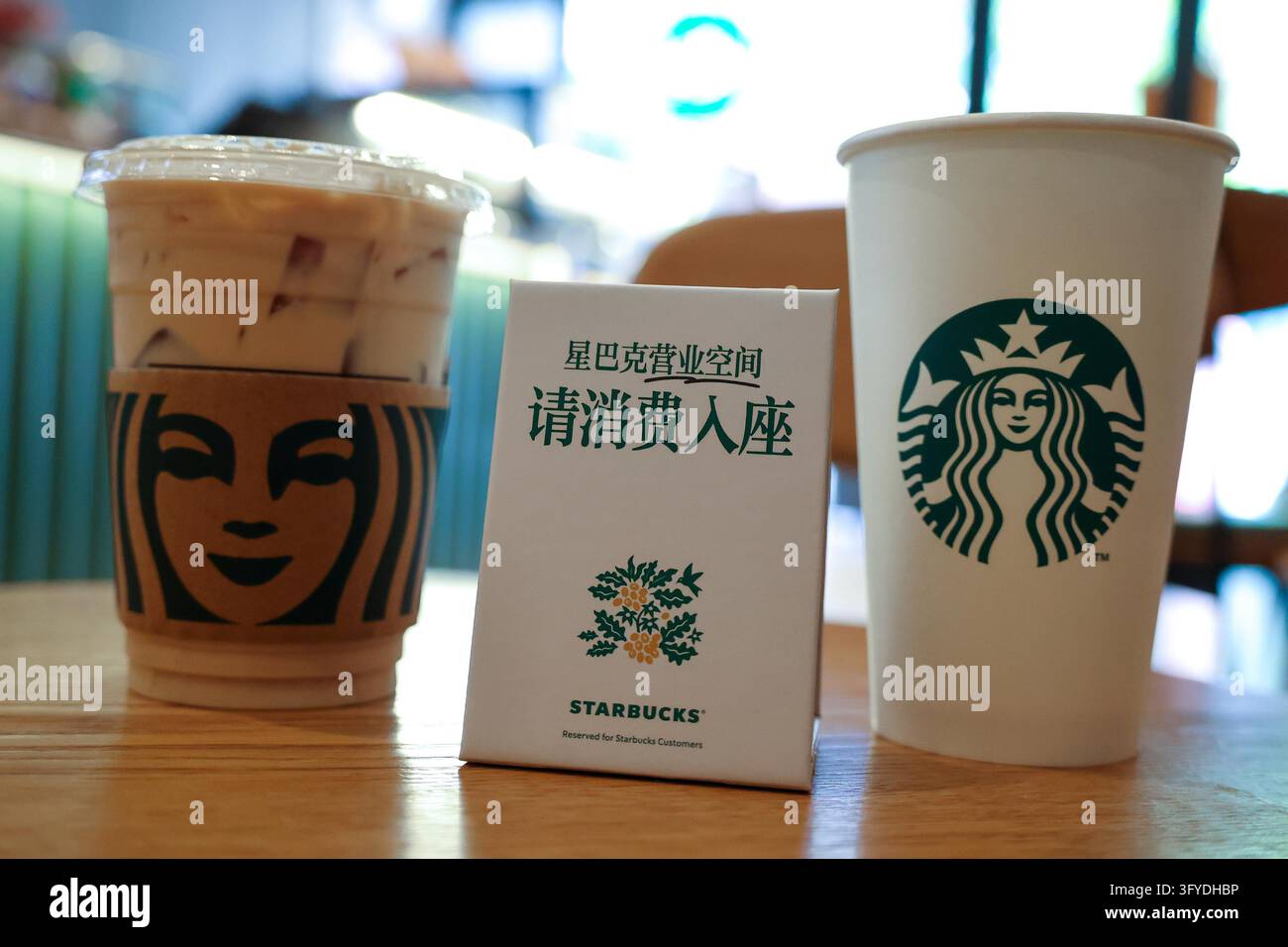 Starbucks stores in Shanghai have set up signs reading 'Please purchase ...