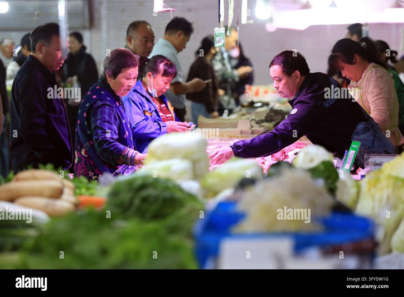 A resident shops at a supermarket in Huai'an, east China's Jiangsu ...