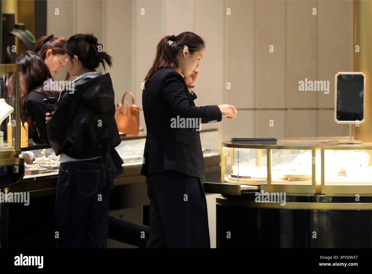 Consumers browse gold jewelry at a store in Huai'an, east China's ...