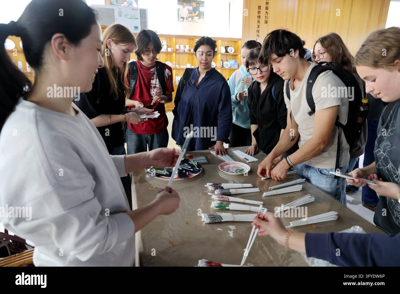 French teenagers select shell porcelain chopsticks at the Marine Shell ...