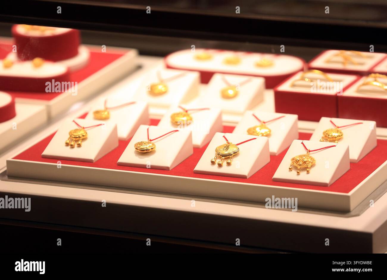 Consumers browse gold jewelry at a store in Huai'an, east China's ...