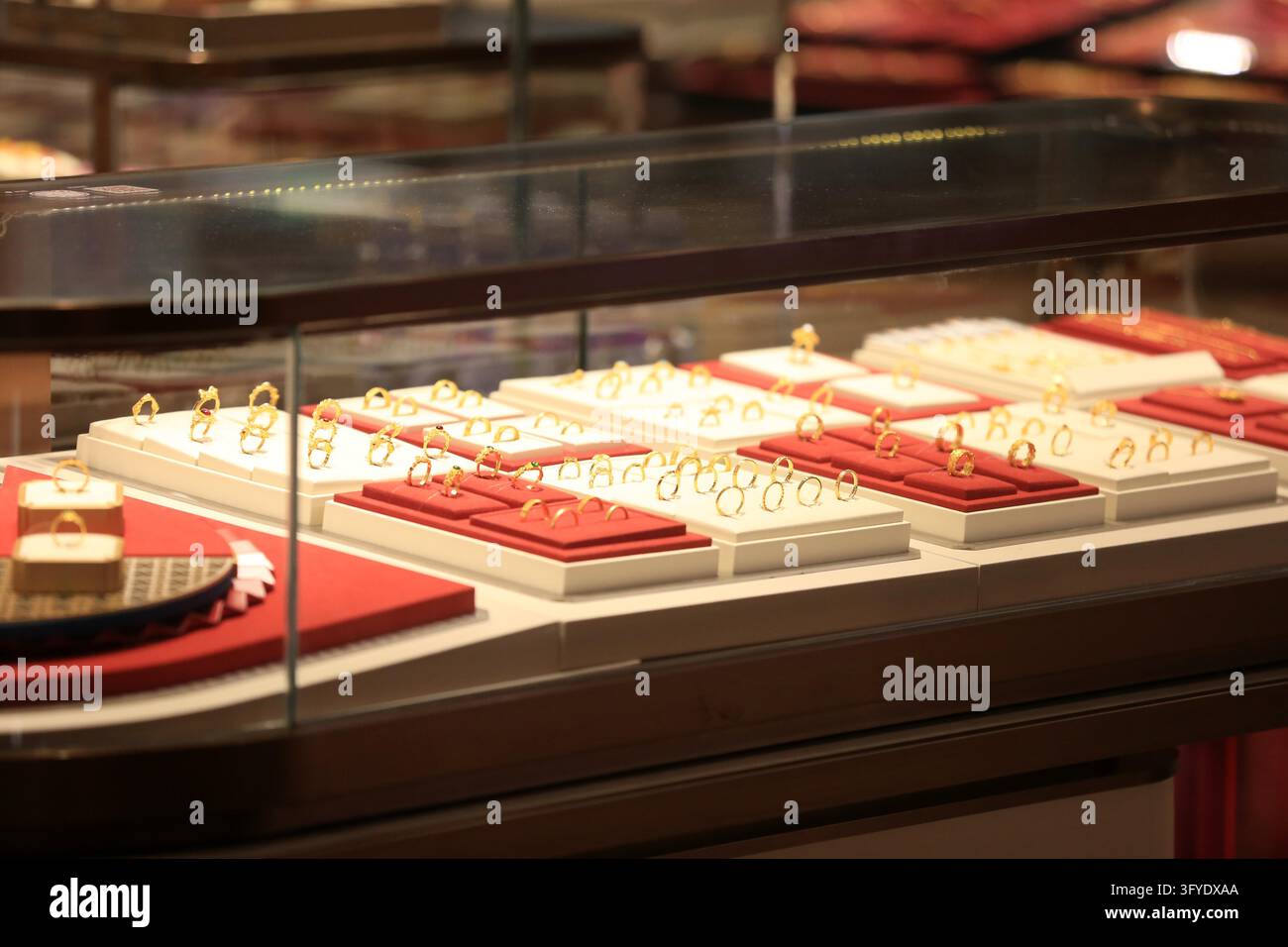Consumers browse gold jewelry at a store in Huai'an, east China's ...