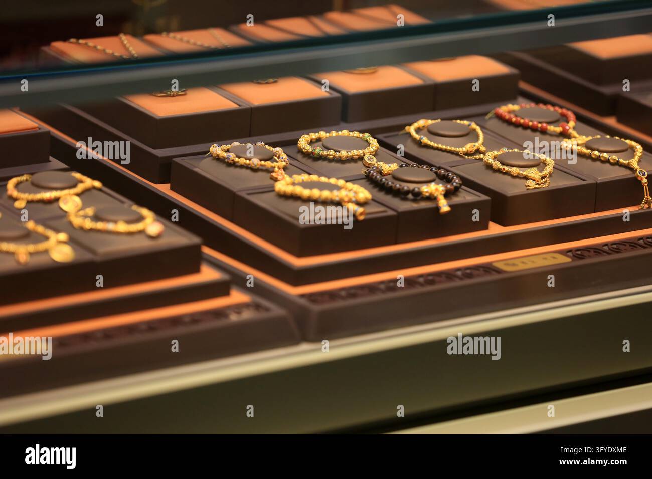 Consumers browse gold jewelry at a store in Huai'an, east China's ...