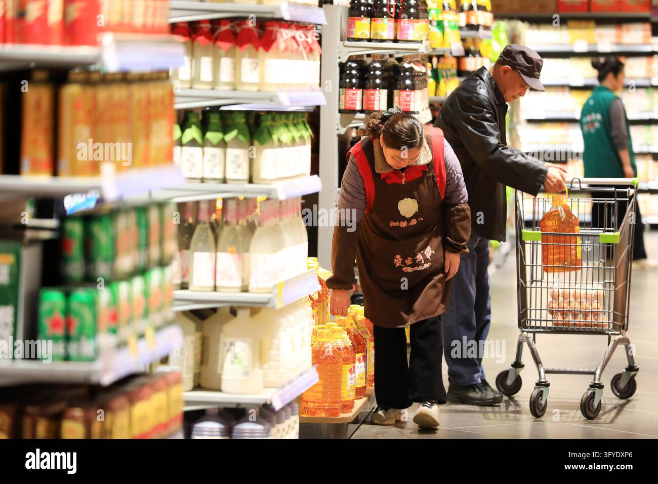 A resident shops at a supermarket in Huai'an, east China's Jiangsu ...